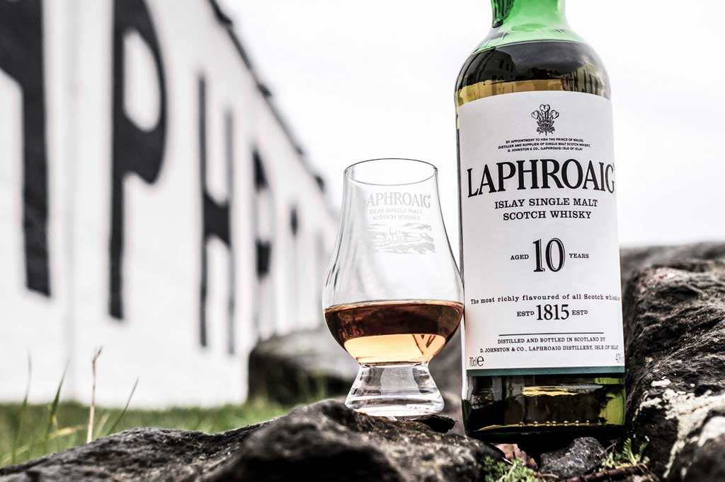 Close upward view of Laphroaig 10 year old whisky bottle outside the Laphroaig distillery on Islay