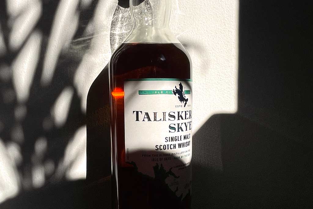 Close view of Talisker Skye whisky bottle in bright sunlight