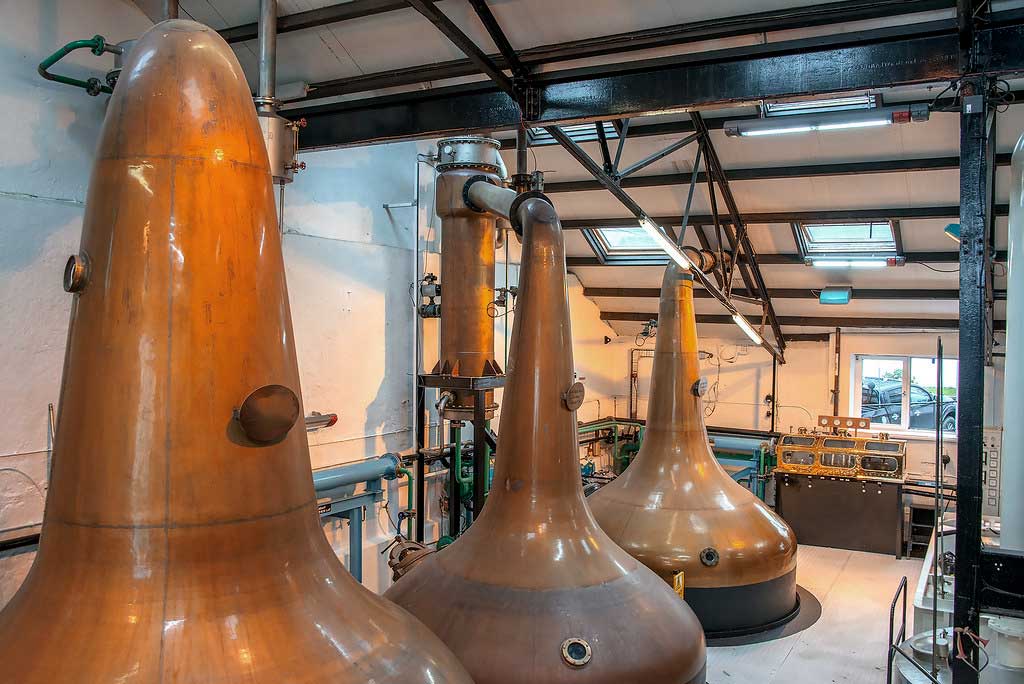 Copper pot stills inside Bowmore whisky distillery