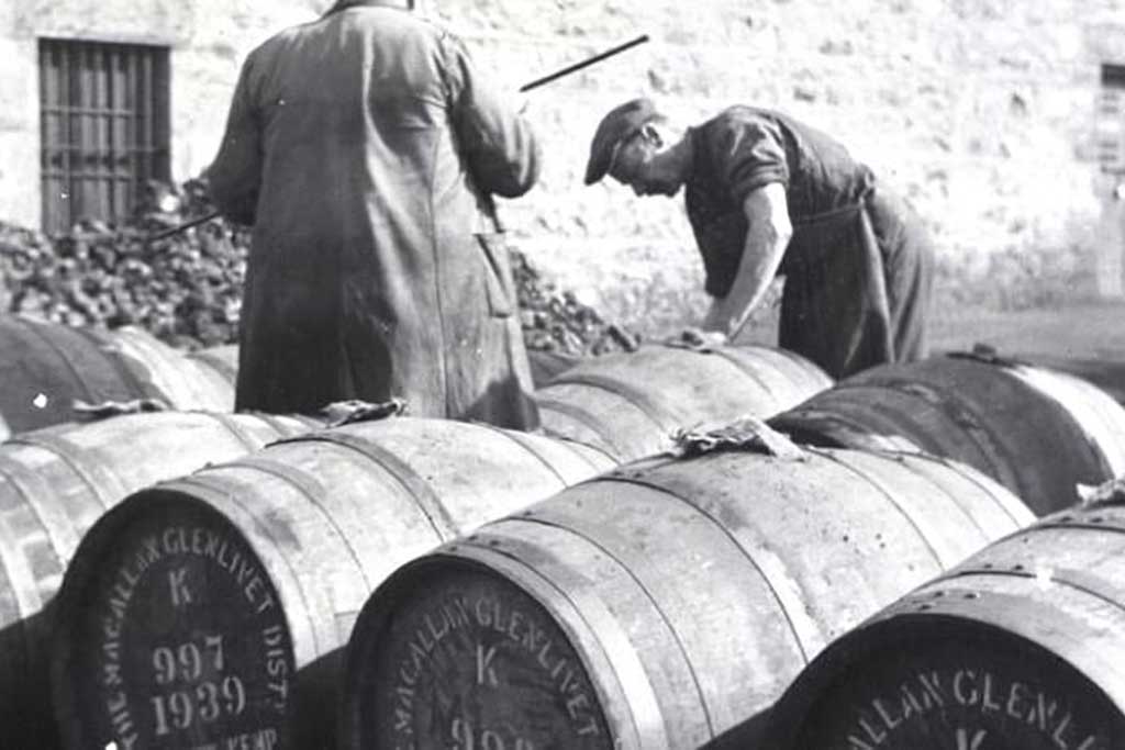 Greyscale image of men inspecting Macallan whisky casks