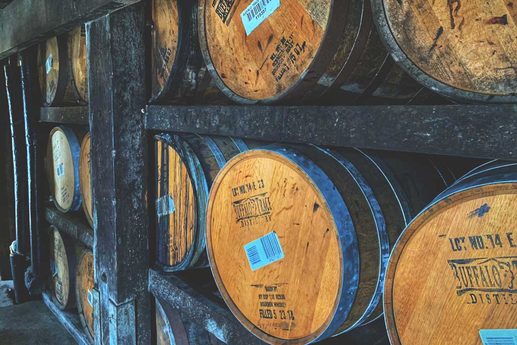Oak barrels of Buffalo Trace whiskey stacked inside rickhouse