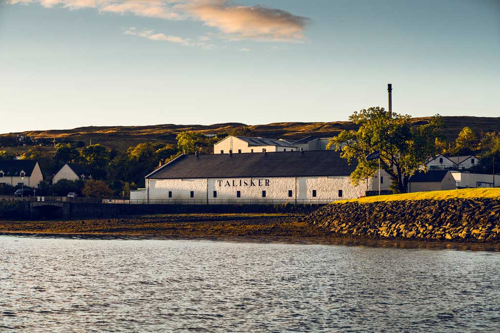 Talisker whisky distillery building on clear sunny day