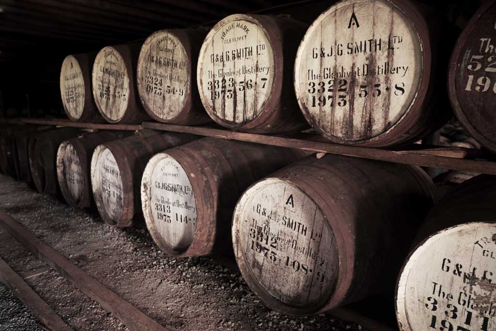 Very old Glenlivet whisky casks inside dark dunnage