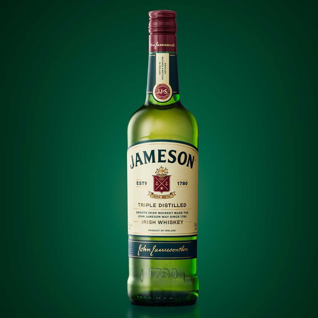 Bottle of Jameson Irish whiskey in front of green background