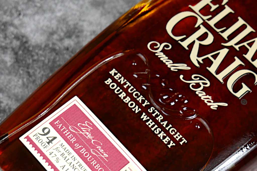 Close view of Elijah Craig small batch bourbon bottle lying on its side