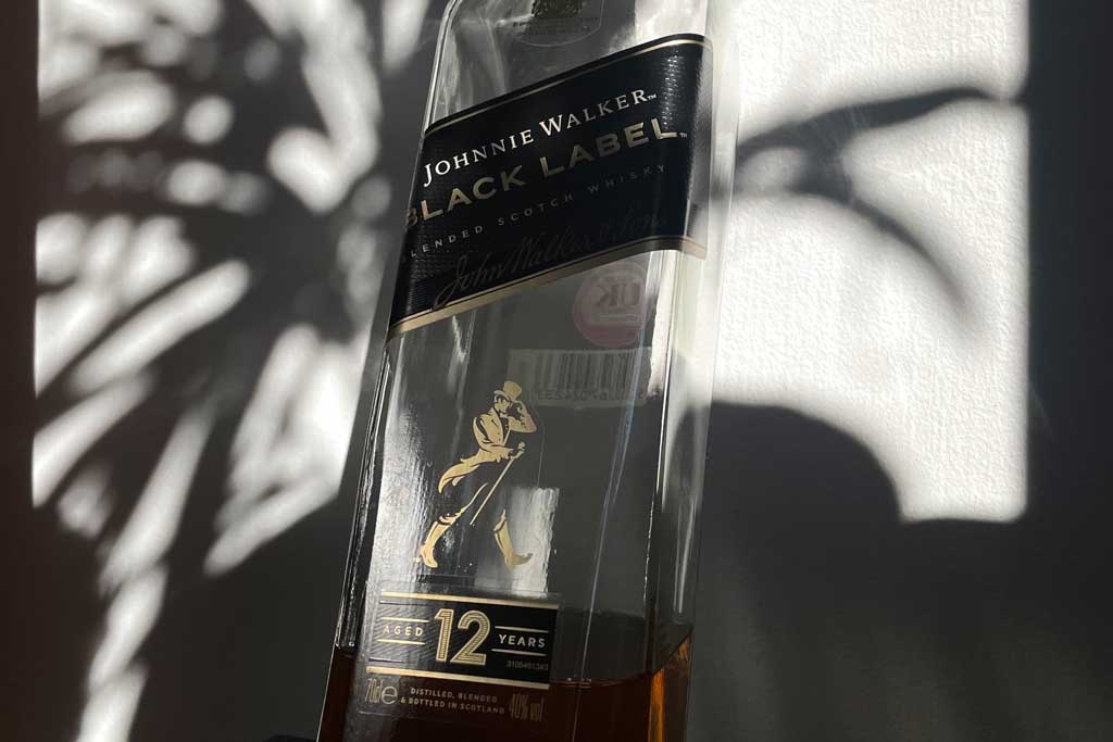 Close view of Johnnie Walker Black label whisky bottle in bright sunlight