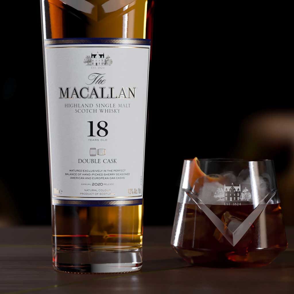 Close view of Macallan 18 year old double cask matured whisky besides rocks glass on bar top