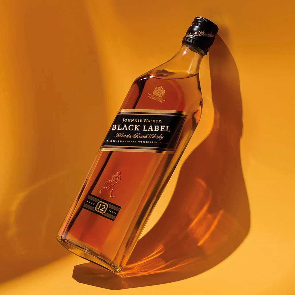 Johnnie Walker Black Label whisky in front of yellow background