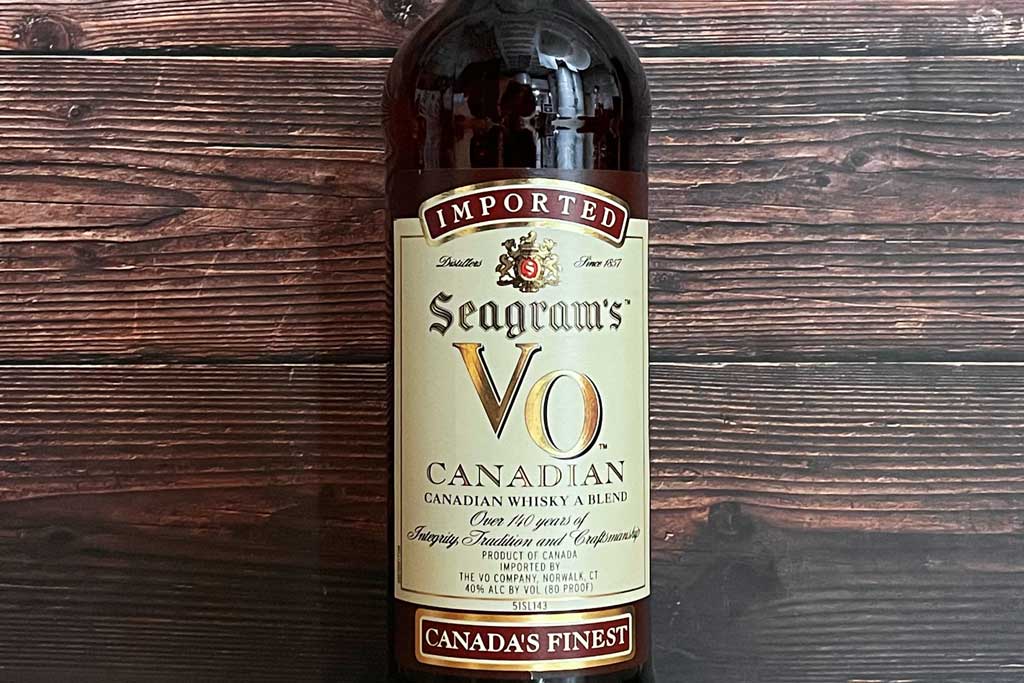 Bottle of Seagram's VO Canadian whisky on its side on wooden table