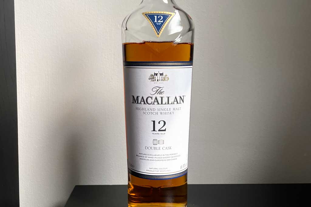 Bottle of Macallan Double Cask whisky in front of white wall