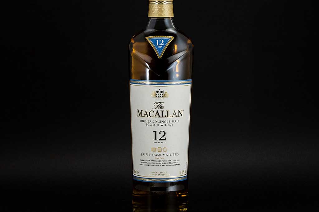 Front view of Macallan 12 year old triple cask whisky bottle