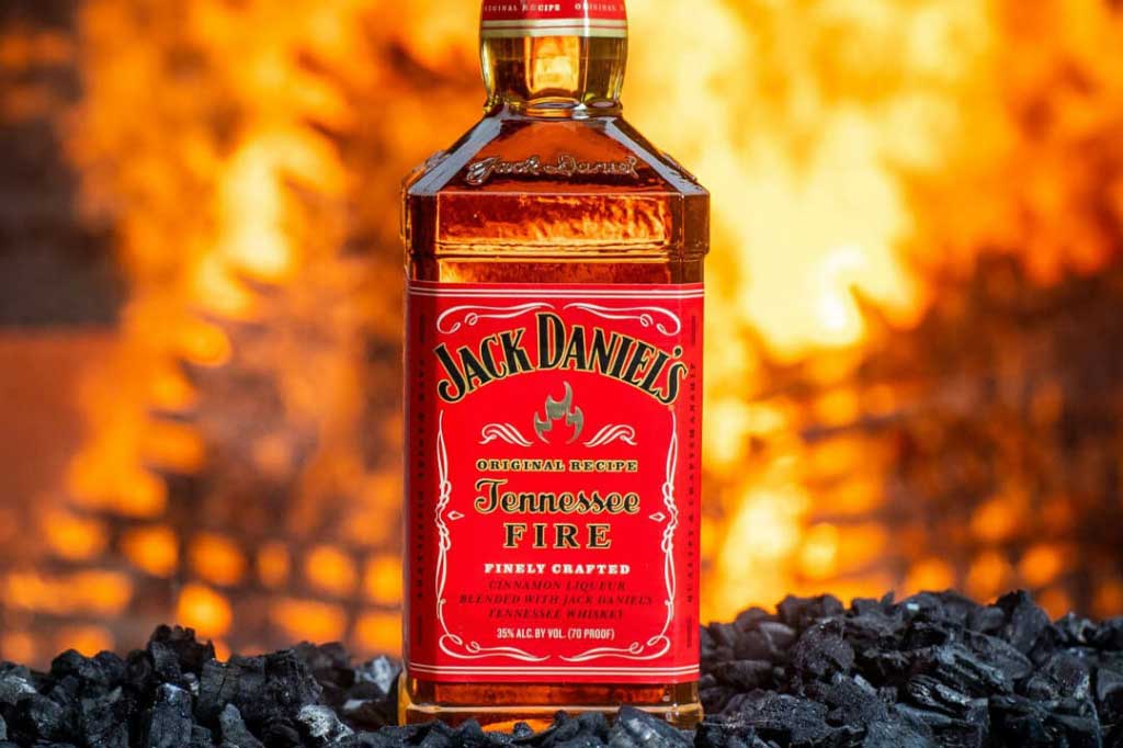 Jack Daniel's Tennessee Fire whiskey bottle in front of flames