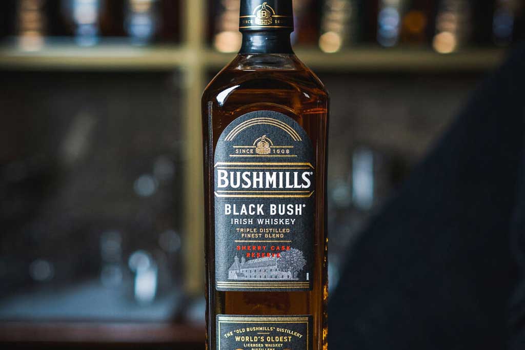 Bottle of Bushmills Black Bush Whiskey on bar top