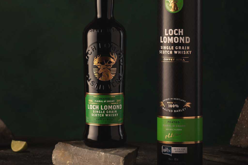 Bottle of Loch Lomond Peated Single Grain Whisky in front of green background