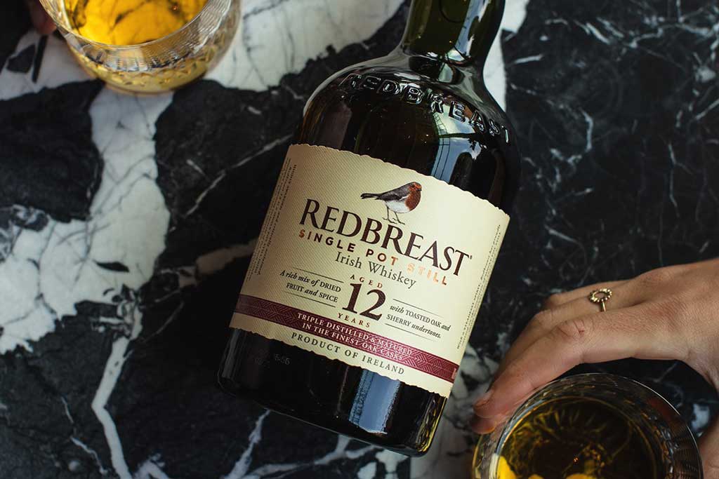 Bottle of Redbreast 12 Year Old Whiskey lying on marble surface