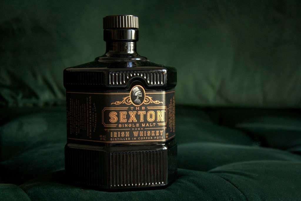 Bottle of The Sexton Single Malt Irish Whiskey on green velvet