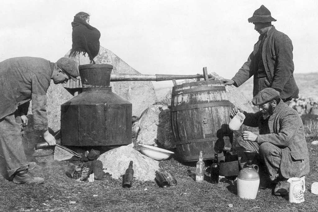 Greyscale image of old fashioned Irish poitin production using a fire and pot still